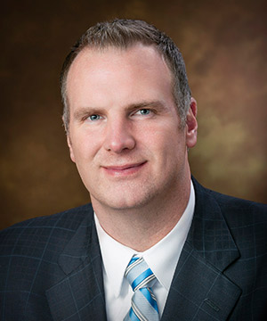 headshot of man in a suit